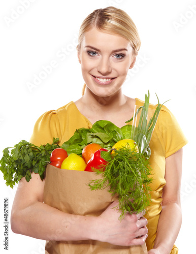 Photo: Young woman with a grocery shopping bag. Isolated on white backg Young woman with a grocery shopping bag. Isolated on white backg