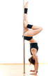 The beautiful sports woman and dancing pole