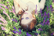 Photo: Girl liyng on spring grass and flowers. Girl liyng on spring grass and flowers.