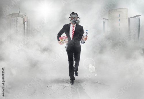 Photo: Business man with gas mask running, survival concept Business man with gas mask running, survival concept