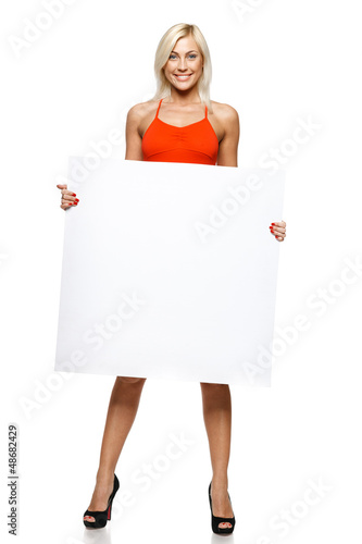 Photo: Smiling woman in full length holding empty banner Smiling woman in full length holding empty banner