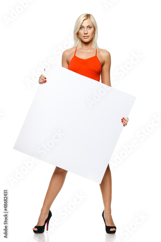 Photo: Calm woman in full length holding empty banner Calm woman in full length holding empty banner