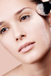 Young beautiful woman with a powder on the face