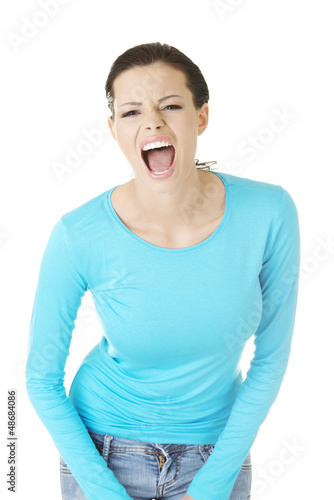 Photo: Young casual woman screaming with anger Young casual woman screaming with anger