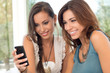 Two Women Looking At Mobile Phone