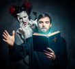 Priest evicting demons, conceptual photo