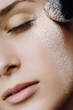 Photo: Young beautiful woman with a powder on the face Young beautiful woman with a powder on the face