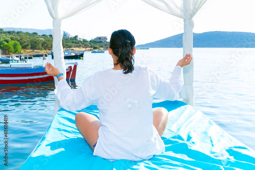Photo: Woman at meditation at the sea at sunrise Woman at meditation at the sea at sunrise