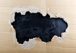 ripped hole in cardboard on blackboard