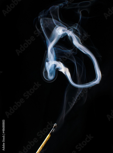 Photo: Fireless match and circle of smoke on black background Fireless match and circle of smoke on black background