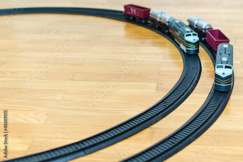 Photo: Two toy trains on wooden floor Two toy trains on wooden floor