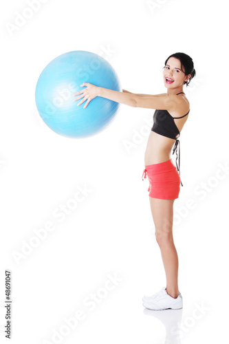 Photo: Beautiful young woman with pilates exercise ball. Beautiful young woman with pilates exercise ball.