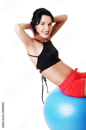 Photo: Beautiful young woman with pilates exercise ball. Beautiful young woman with pilates exercise ball.