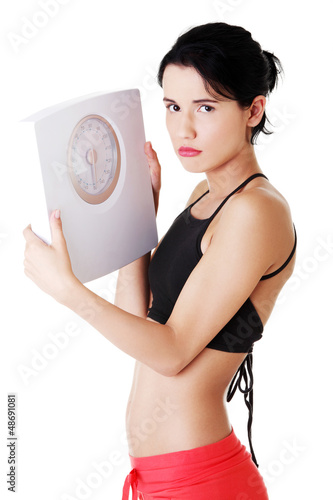 Photo: Frustrated woman with scale Frustrated woman with scale