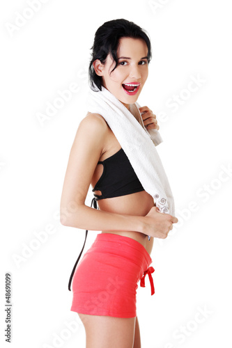Photo: Woman in sports clothes with towel on neck Woman in sports clothes with towel on neck