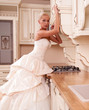 Photo: beautiful bride stands in the kitchen beautiful bride stands in the kitchen