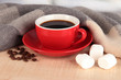 cup of coffee with scarf on table in room