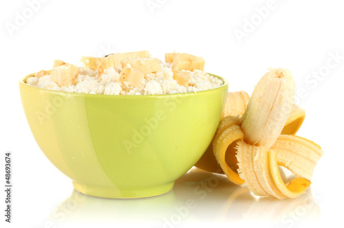 Photo: Cottage cheese in color bowl with banana, isolated on white Cottage cheese in color bowl with banana, isolated on white