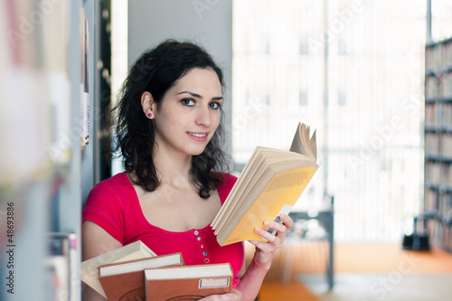 Photo: Potrait of a college student in a library Potrait of a college student in a library