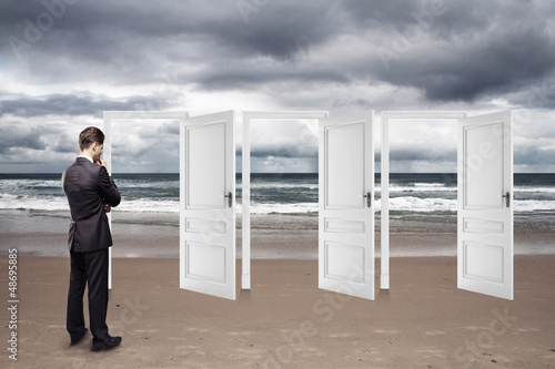 Photo: businessman standing on beach businessman standing on beach