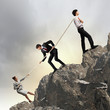 Three business people pulling rope
