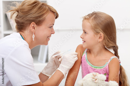 Photo: Brave little girl receiving injection Brave little girl receiving injection