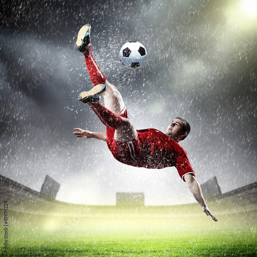 Photo: football player striking the ball football player striking the ball
