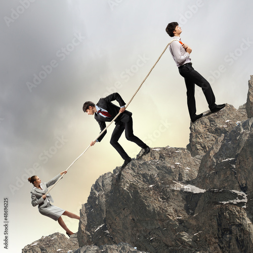 Photo: Three business people pulling rope Three business people pulling rope