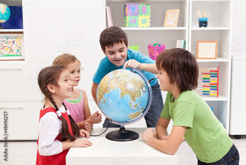 Photo: Kids looking at earth globe Kids looking at earth globe
