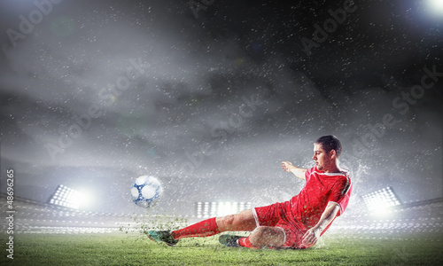 Photo: football player striking the ball football player striking the ball