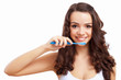 Young woman at home brushing teeth
