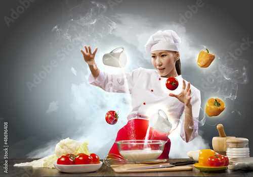 Photo: Asian female cooking with magic Asian female cooking with magic