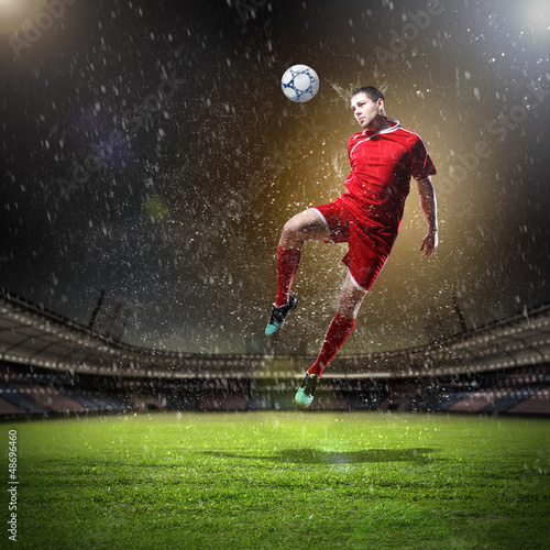 Photo: football player striking the ball football player striking the ball