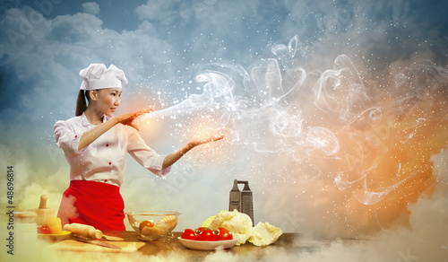 Photo: Asian female cooking with magic Asian female cooking with magic