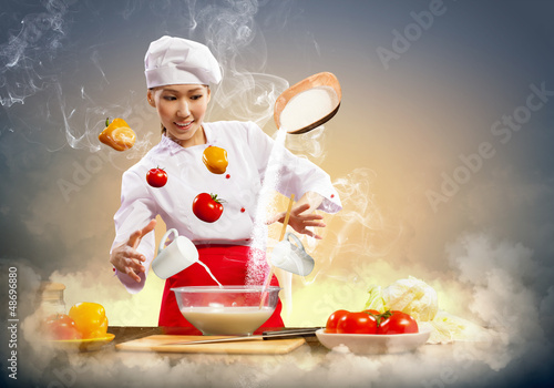 Photo: Asian female cooking with magic Asian female cooking with magic