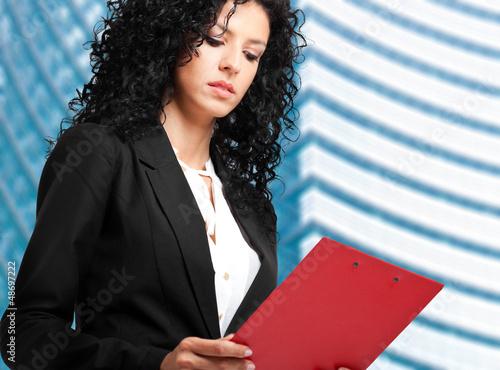 Photo: Businesswoman reading some documents Businesswoman reading some documents