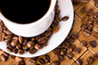 Photo: Coffee cup with fresh coffe beans for breakfast Coffee cup with fresh coffe beans for breakfast