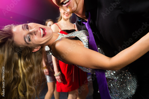 Photo: party people dancing in disco club party people dancing in disco club