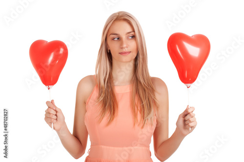 Photo: Young woman choosing one of balloons Young woman choosing one of balloons