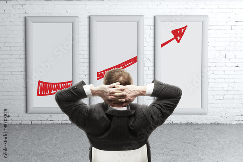 Photo: man looking growth of chart man looking growth of chart