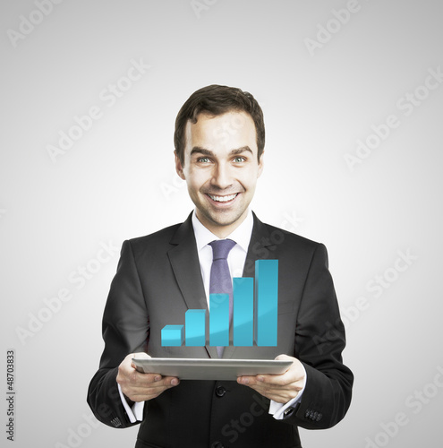 Photo: businessman hold tablet with growth chart businessman hold tablet with growth chart