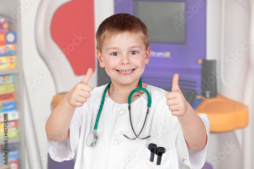 Photo: Adorable child with doctor uniform saying Ok Adorable child with doctor uniform saying Ok