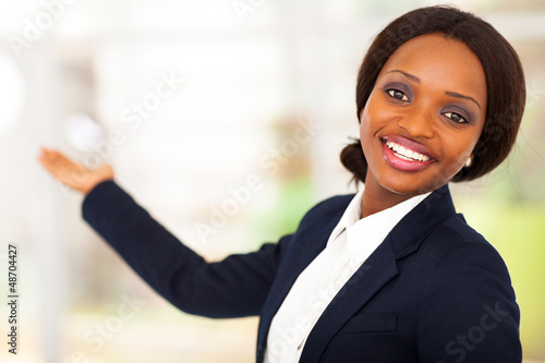 Photo: cheerful african american businesswoman presenting cheerful african american businesswoman presenting