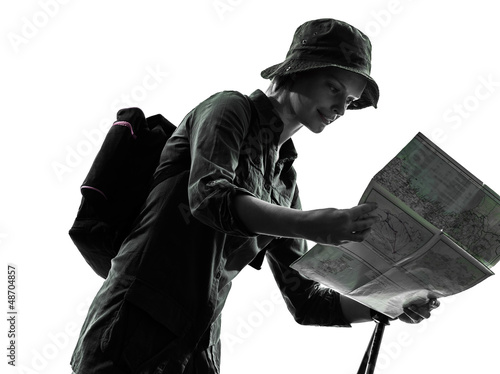 Photo: woman trekker trekking looking at map silhouette woman trekker trekking looking at map silhouette
