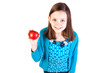 a young girl holding a delicious red apple