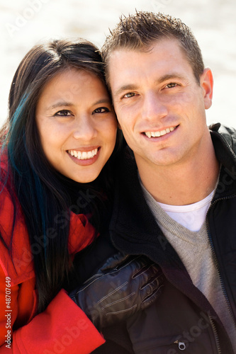 Photo: Cute diverse couple in the snow portrait Cute diverse couple in the snow portrait