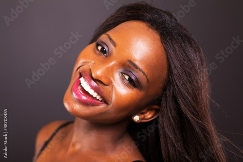 Photo: happy young african american woman face closeup happy young african american woman face closeup