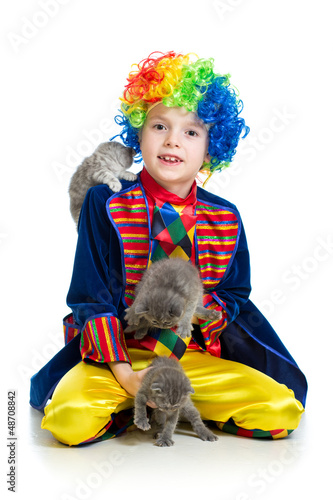 Photo: Boy clown training kittens over the white background Boy clown training kittens over the white background
