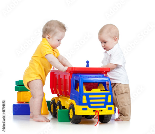 Photo: two little children playing with color toys two little children playing with color toys