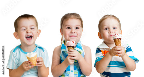 Photo: happy children boy and girls eating ice cream in studio isolated happy children boy and girls eating ice cream in studio isolated
